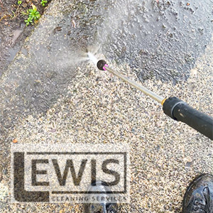 Pressure washing driveway to remove dirt, stains, and moss in Cardiff