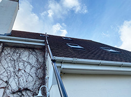 Water fed pole cleaning a high up velux window by Lewis Cleaning Services